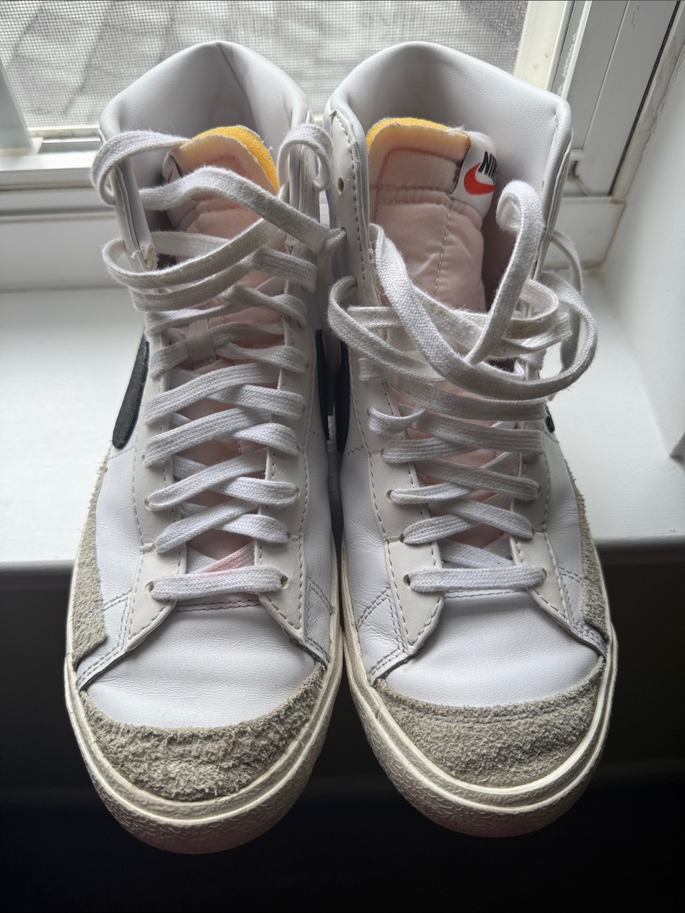 Nike White High-Top Sneakers with Black Swoosh and Yellow Tongue